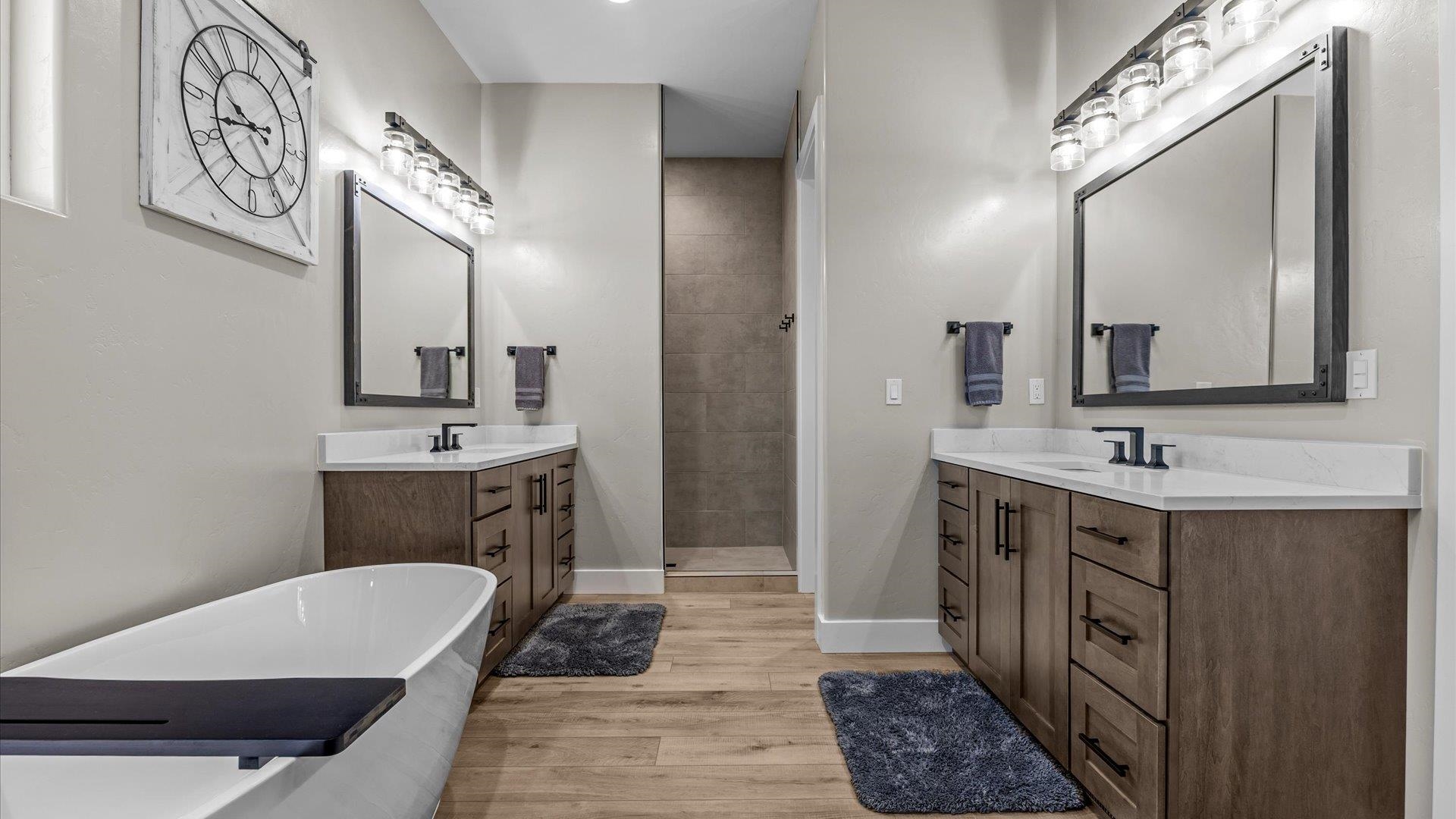 1774 Trapper Court Delta, CO 81416 - Photo 15 of 42 a bathroom with a double vanity sink a mirror and a bathtub