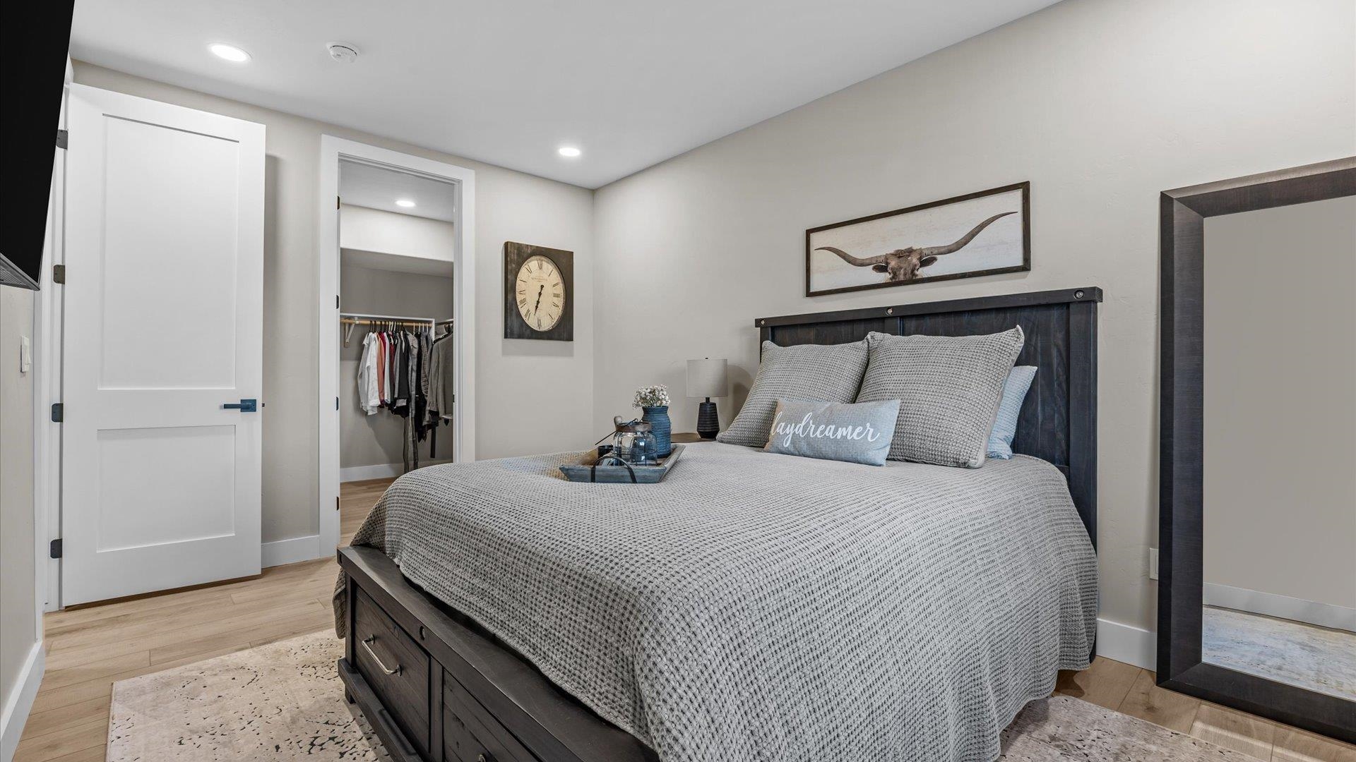 1774 Trapper Court Delta, CO 81416 - Photo 26 of 42 a bedroom with a bed and a mirror