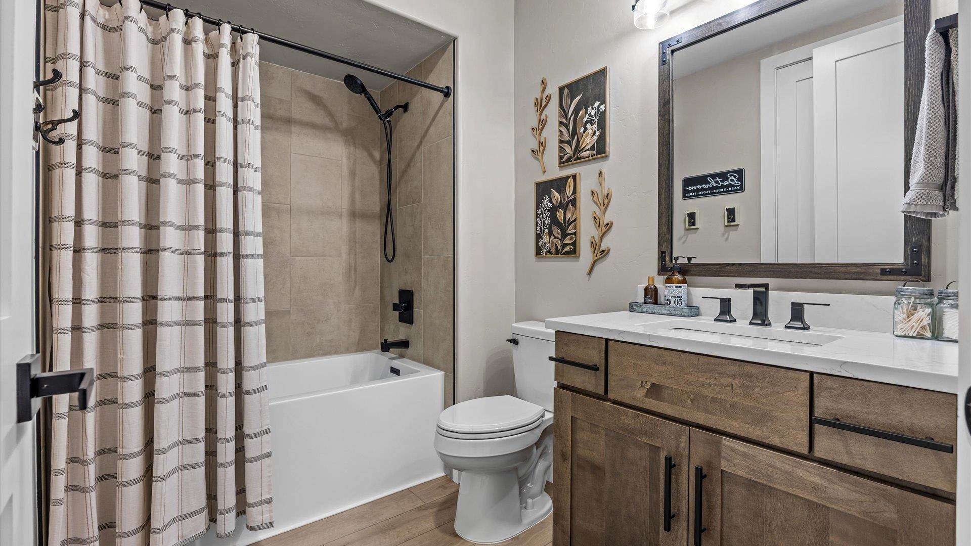 1774 Trapper Court Delta, CO 81416 - Photo 27 of 42 a bathroom with a double vanity sink toilet mirror and shower