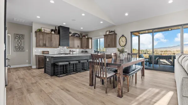 a kitchen with lots of counter top space a sink appliances and cabinets