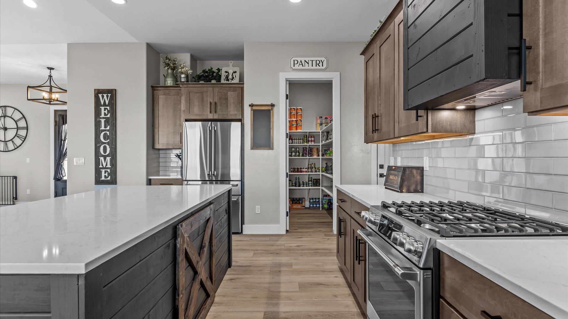 1774 Trapper Court Delta, CO 81416 - Photo 9 of 42 a kitchen with stainless steel appliances granite countertop a stove a sink and a refrigerator