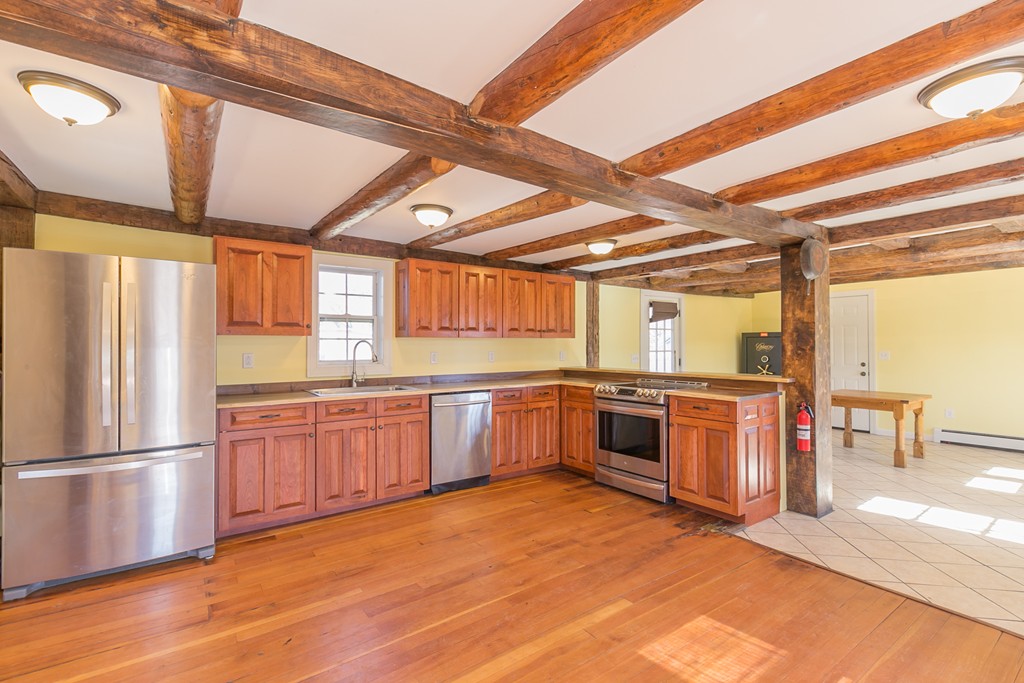1161 Thompson Road, Unit RD Thompson, CT 06277 - Photo 3 of 13 a large kitchen with stainless steel appliances wooden floor and a large window