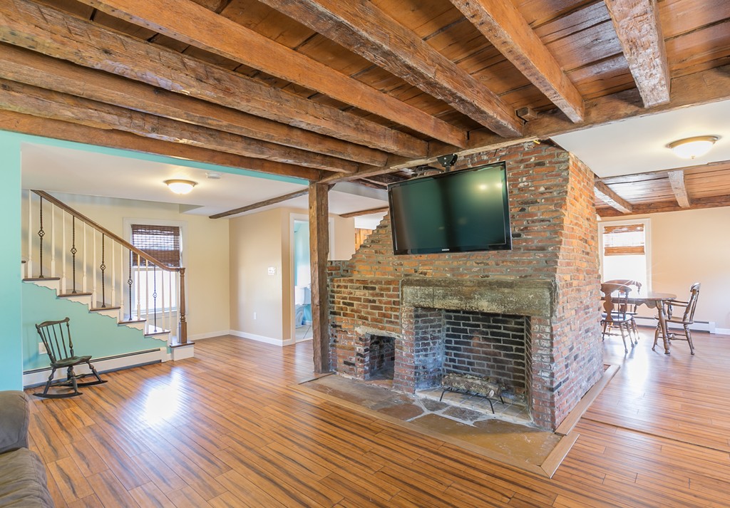 1161 Thompson Road, Unit RD Thompson, CT 06277 - Photo 5 of 13 a living room with fireplace furniture and a wooden floor
