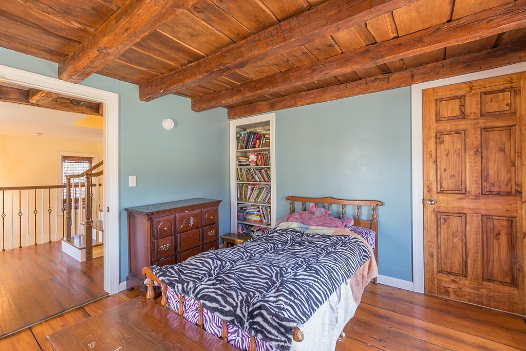 1161 Thompson Road, Unit RD Thompson, CT 06277 - Photo 8 of 13 a bedroom with a bed and wooden floor