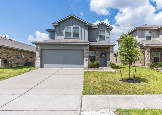 23123 Barrington Bluff Trail Spring, TX 77373 - Photo 1 of 50 a front view of a house with a yard and garage