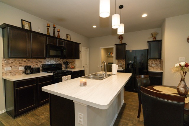 23123 Barrington Bluff Trail Spring, TX 77373 - Photo 13 of 50 a kitchen with a sink a stove a refrigerator and a oven
