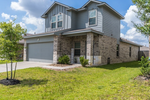 23123 Barrington Bluff Trail Spring, TX 77373 - Photo 2 of 50 a front view of a house with a yard and garage