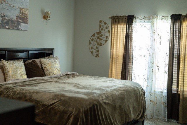 23123 Barrington Bluff Trail Spring, TX 77373 - Photo 28 of 50 a bed sitting in a bedroom next to a window