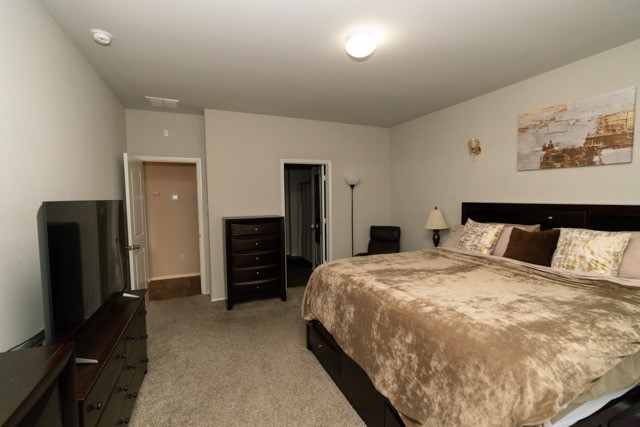 23123 Barrington Bluff Trail Spring, TX 77373 - Photo 29 of 50 a spacious bedroom with a bed and a flat screen tv