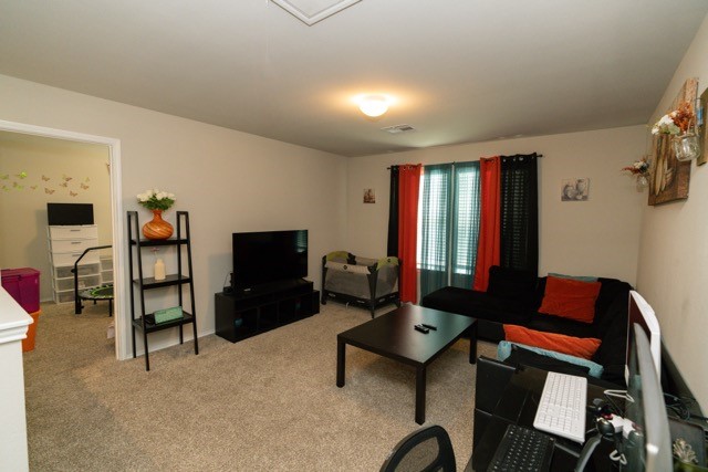 23123 Barrington Bluff Trail Spring, TX 77373 - Photo 32 of 50 a living room with furniture a flat screen tv and a window