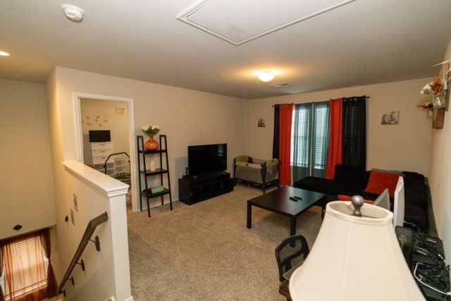 23123 Barrington Bluff Trail Spring, TX 77373 - Photo 38 of 50 a living room with furniture a flat screen tv and gym equipment