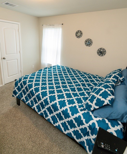 23123 Barrington Bluff Trail Spring, TX 77373 - Photo 42 of 50 a large bed sitting in a bedroom next to a window