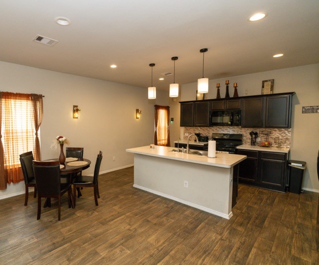 23123 Barrington Bluff Trail Spring, TX 77373 - Photo 10 of 50 a kitchen with kitchen island a sink table and chairs