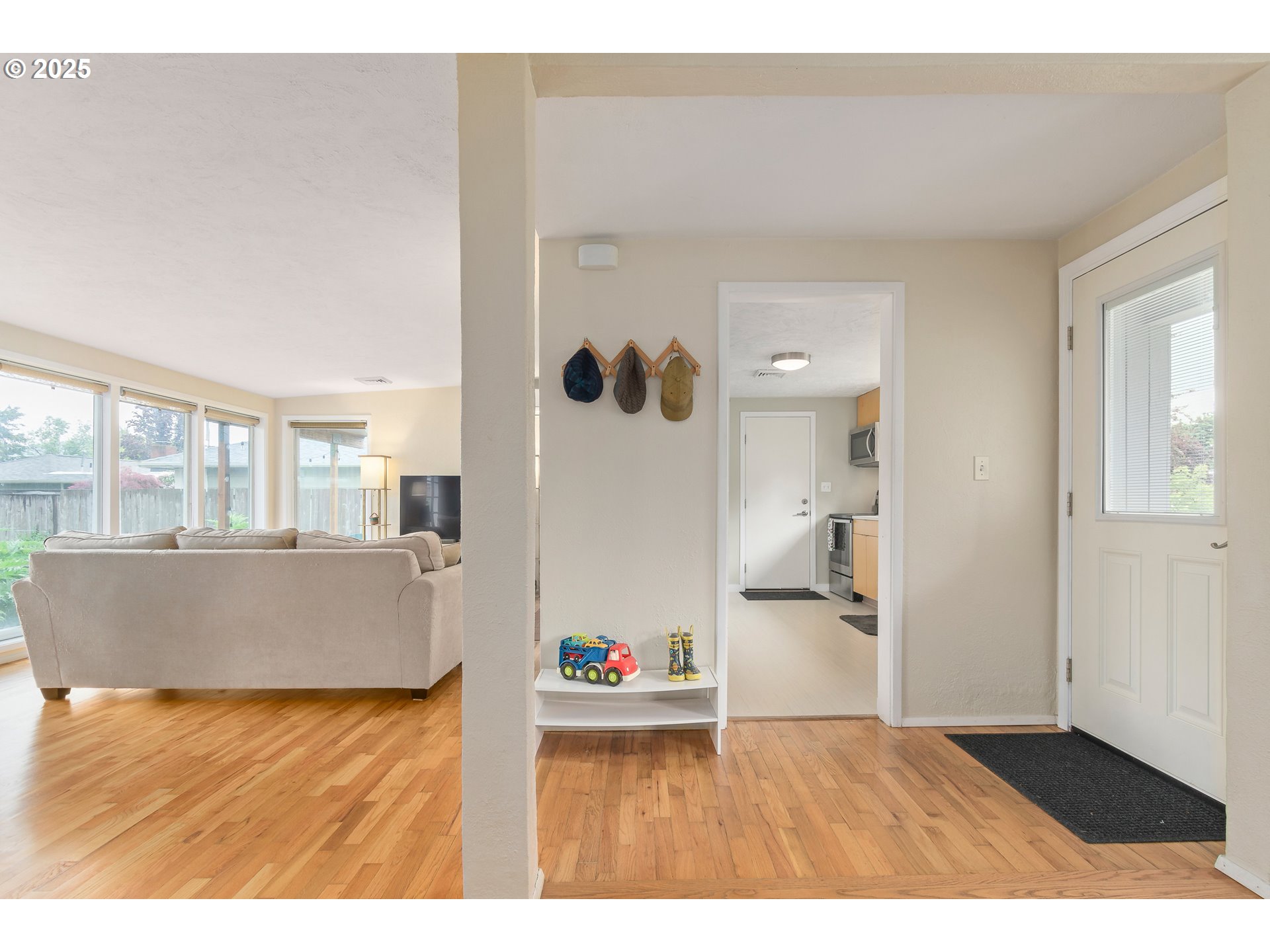 3417 Harlow Road Eugene, OR 97401 - Photo 14 of 40 a living room with a couch and chandelier