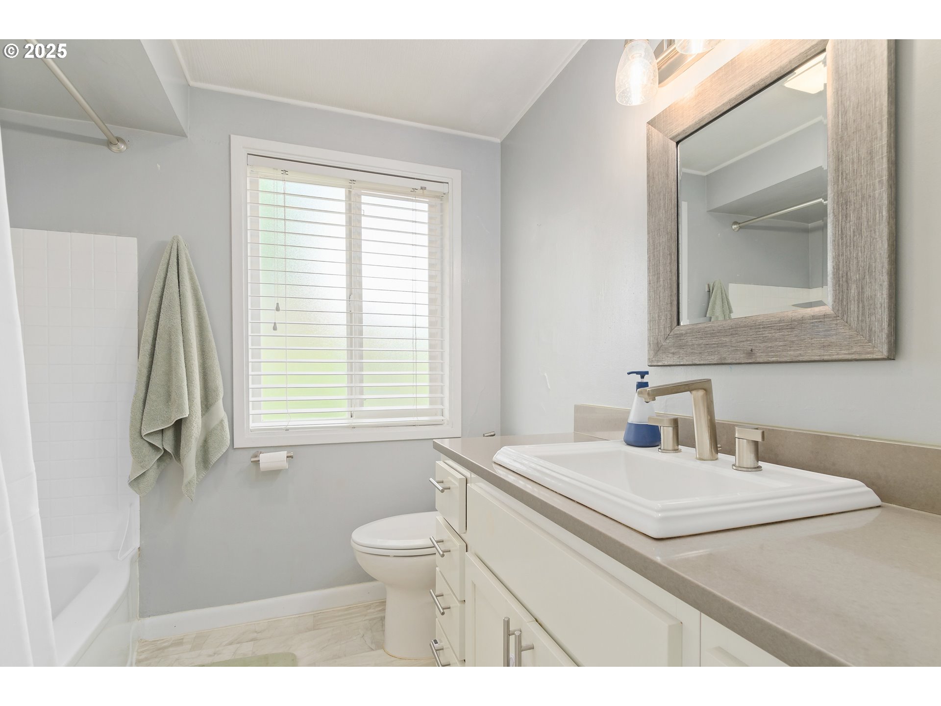 3417 Harlow Road Eugene, OR 97401 - Photo 23 of 40 a bathroom with a sink toilet a mirror and window