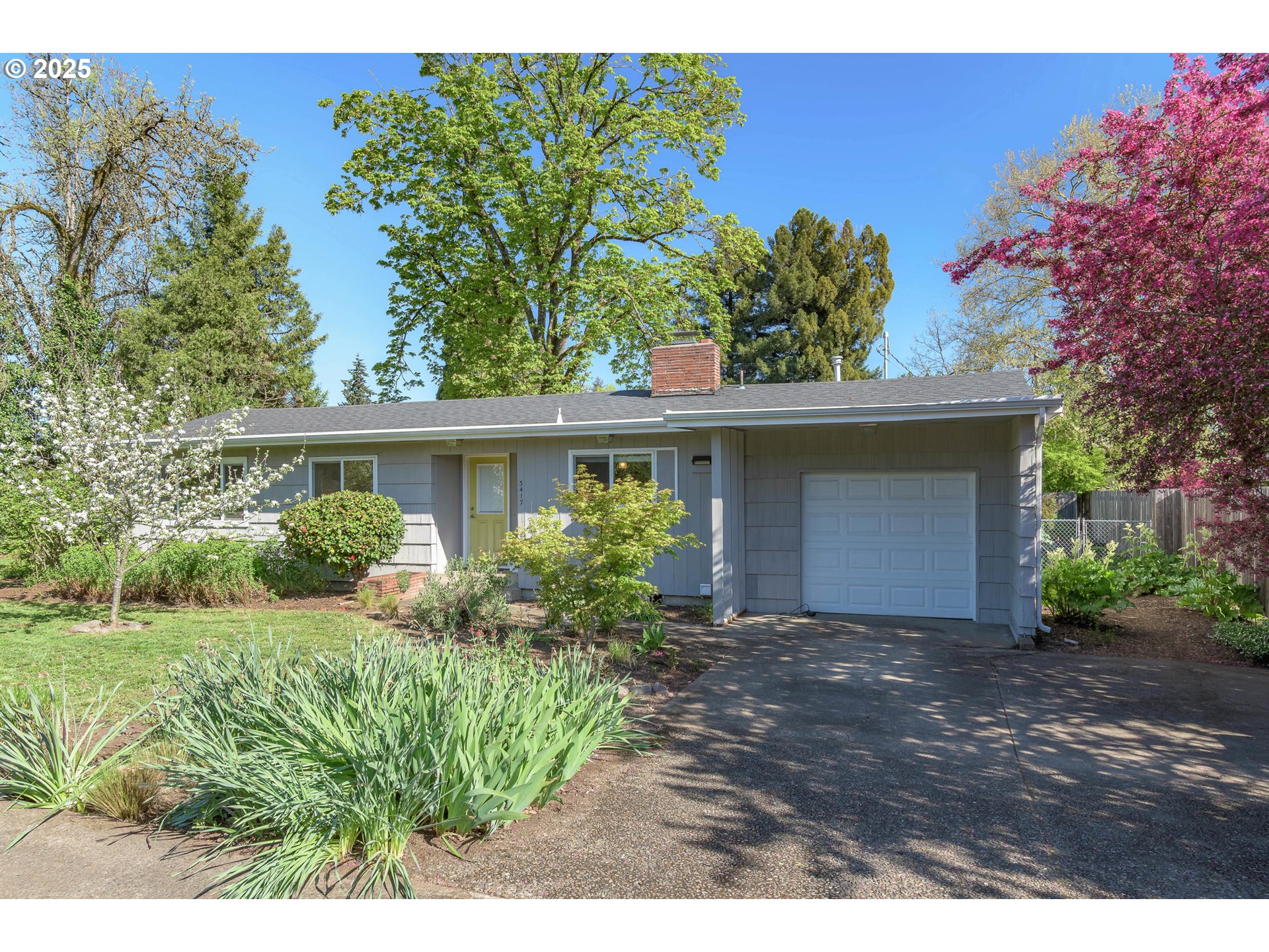 3417 Harlow Road Eugene, OR 97401 - Photo 3 of 40 a front view of a house with a garden
