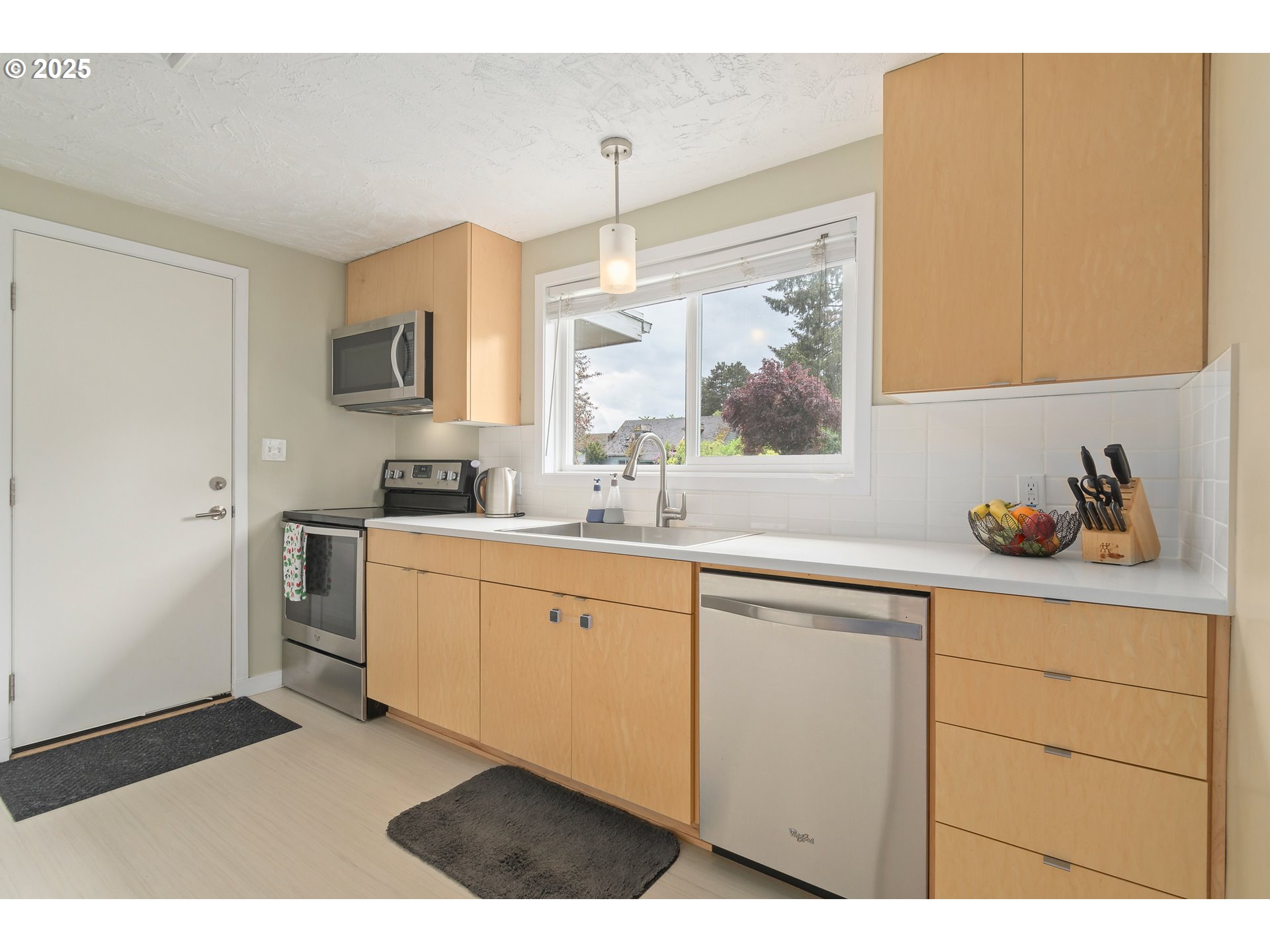 3417 Harlow Road Eugene, OR 97401 - Photo 8 of 40 a kitchen with stainless steel appliances a sink cabinets and a window