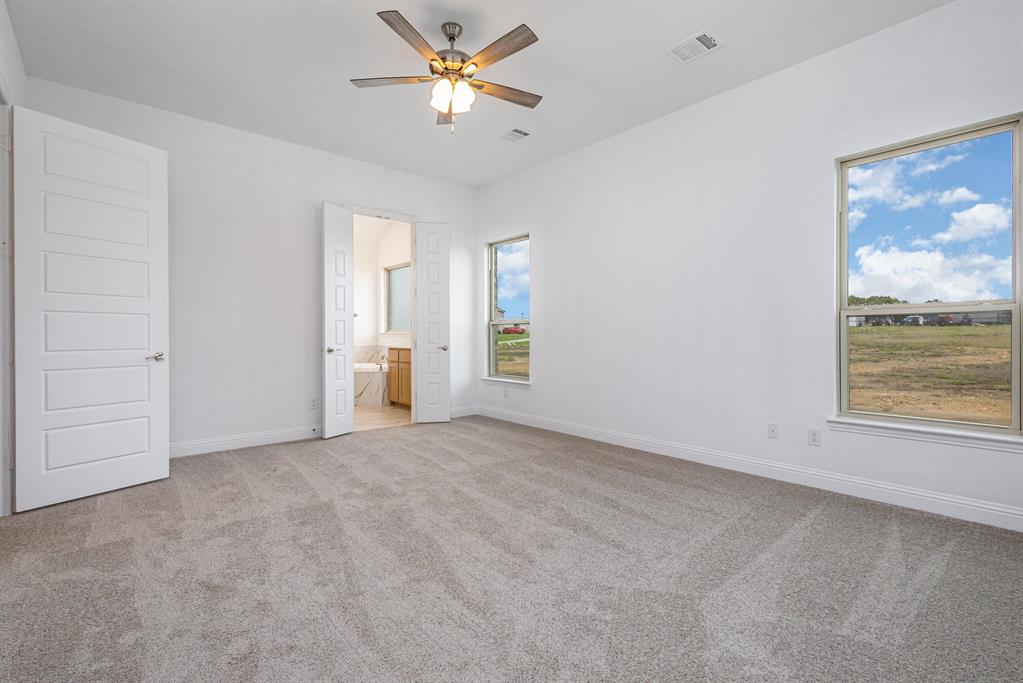 6044 Mango Drive Sanger, TX 76266 - Photo 11 of 27 an empty room with windows and fan