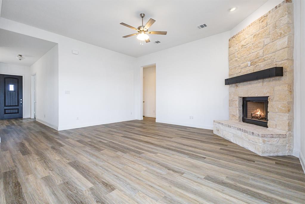 6044 Mango Drive Sanger, TX 76266 - Photo 13 of 27 a view of empty room with wooden floor and fireplace