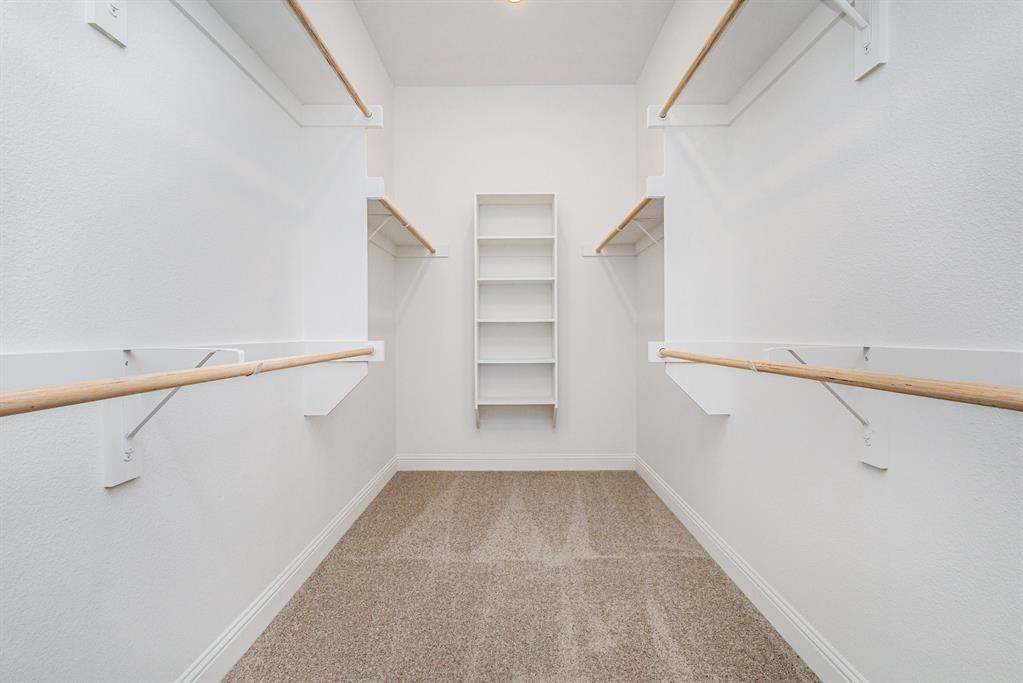 6044 Mango Drive Sanger, TX 76266 - Photo 17 of 27 a view of walk in closet with empty racks