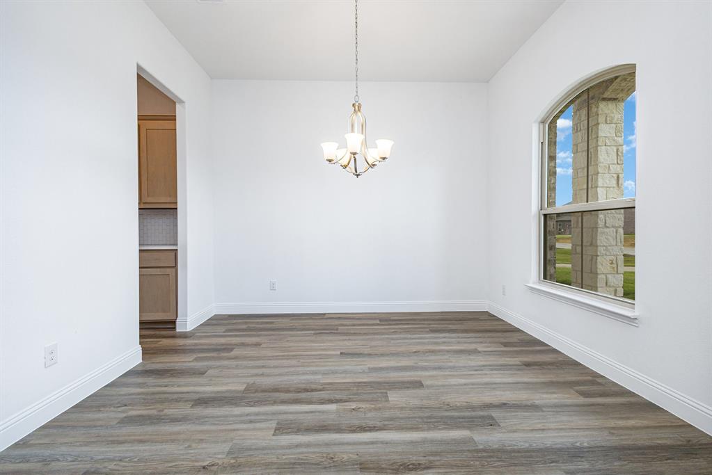 6044 Mango Drive Sanger, TX 76266 - Photo 18 of 27 a view of a livingroom with wooden floor and a window