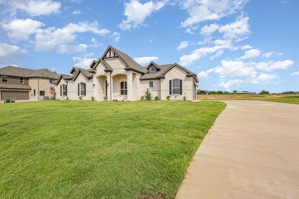 6044 Mango Drive Sanger, TX 76266 - Photo 2 of 27 a front view of a house with a yard and trees