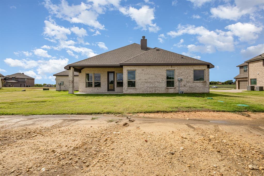 6044 Mango Drive Sanger, TX 76266 - Photo 27 of 27 a front view of a house with a yard