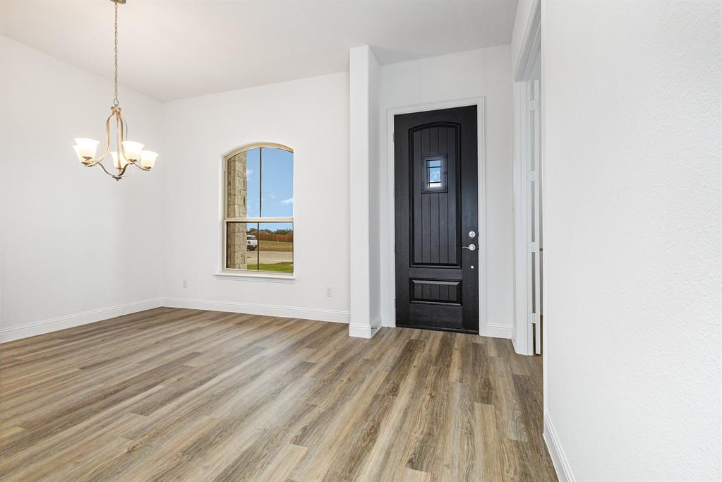 6044 Mango Drive Sanger, TX 76266 - Photo 4 of 27 a view of a room with wooden floor and windows