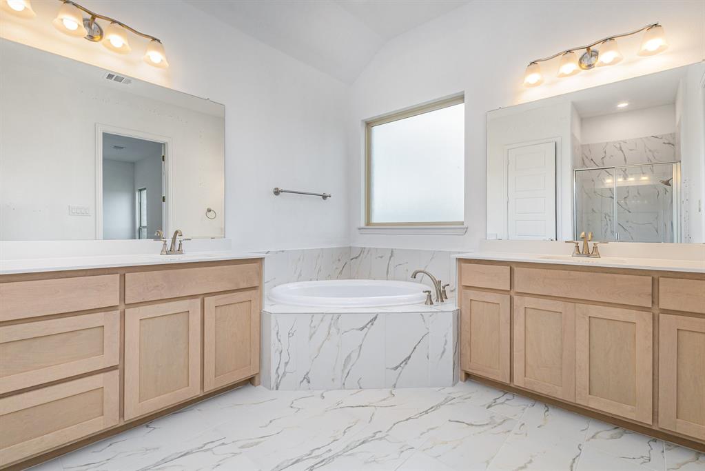 6044 Mango Drive Sanger, TX 76266 - Photo 6 of 27 a bathroom with a sink double vanity mirror and a bathtub