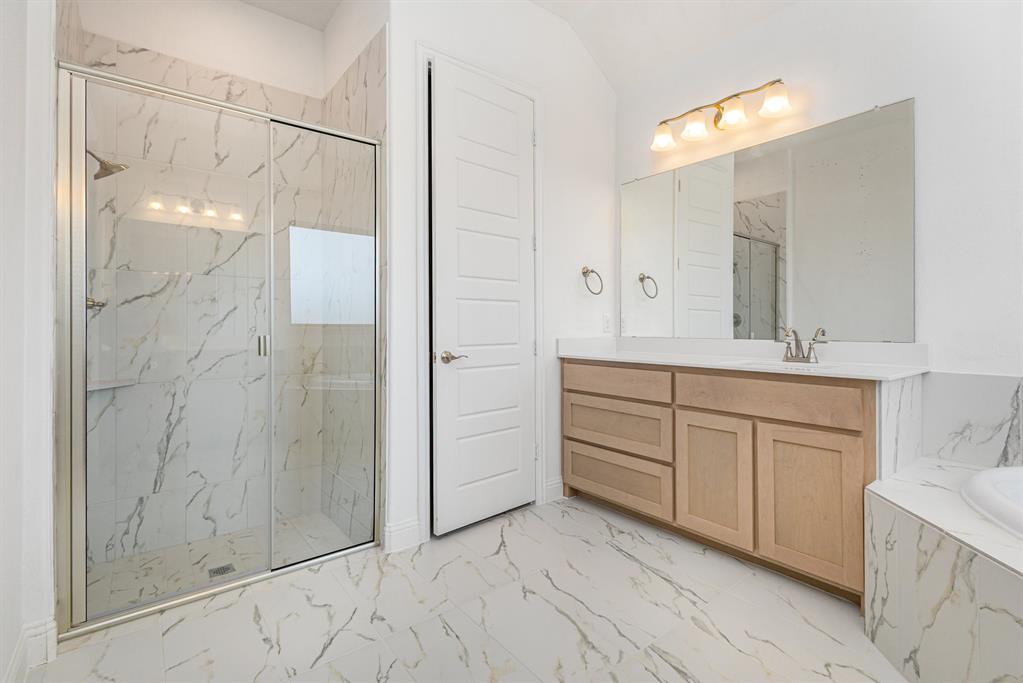 6044 Mango Drive Sanger, TX 76266 - Photo 8 of 27 a bathroom with a sink and a mirror