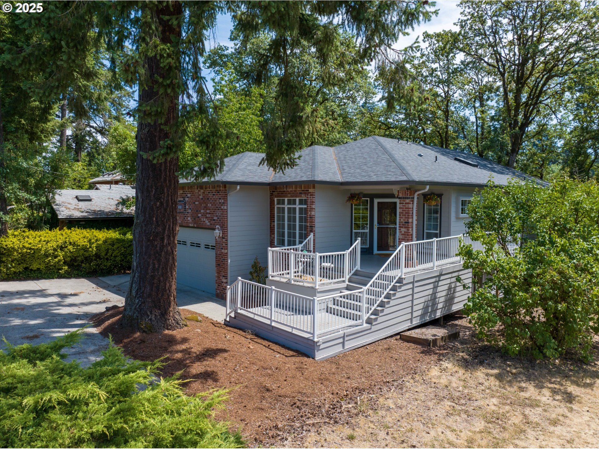 690 North Shepherd Road Washougal, WA 98671 - Photo 12 of 38 a white house covered with tall trees