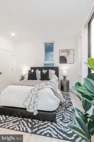 a bedroom with a bed and a painting on the wall