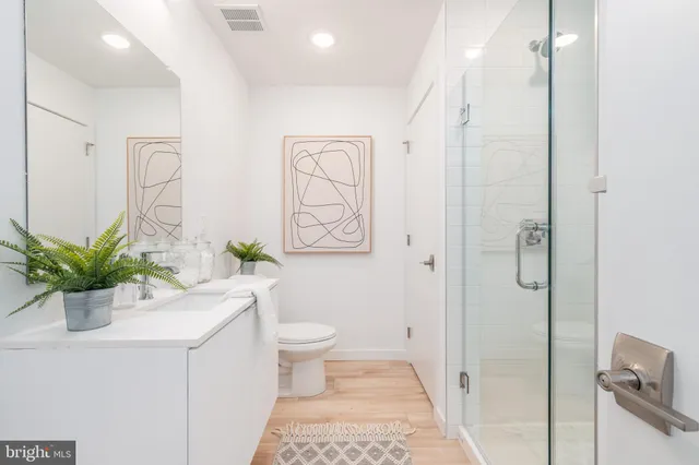 a bathroom with a sink a toilet and a shower