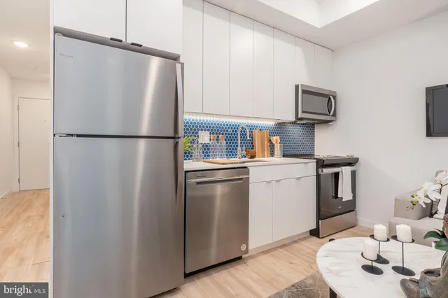a white refrigerator freezer sitting inside of a kitchen