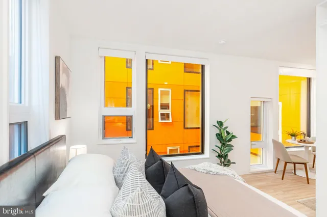 a bedroom with a bed and a large window