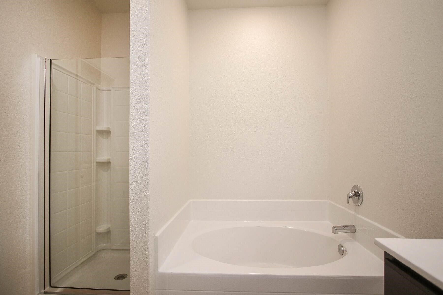 22422 Kennons Way Hockley, TX 77447 - Photo 9 of 11 a close up of a bathtub in a bathroom