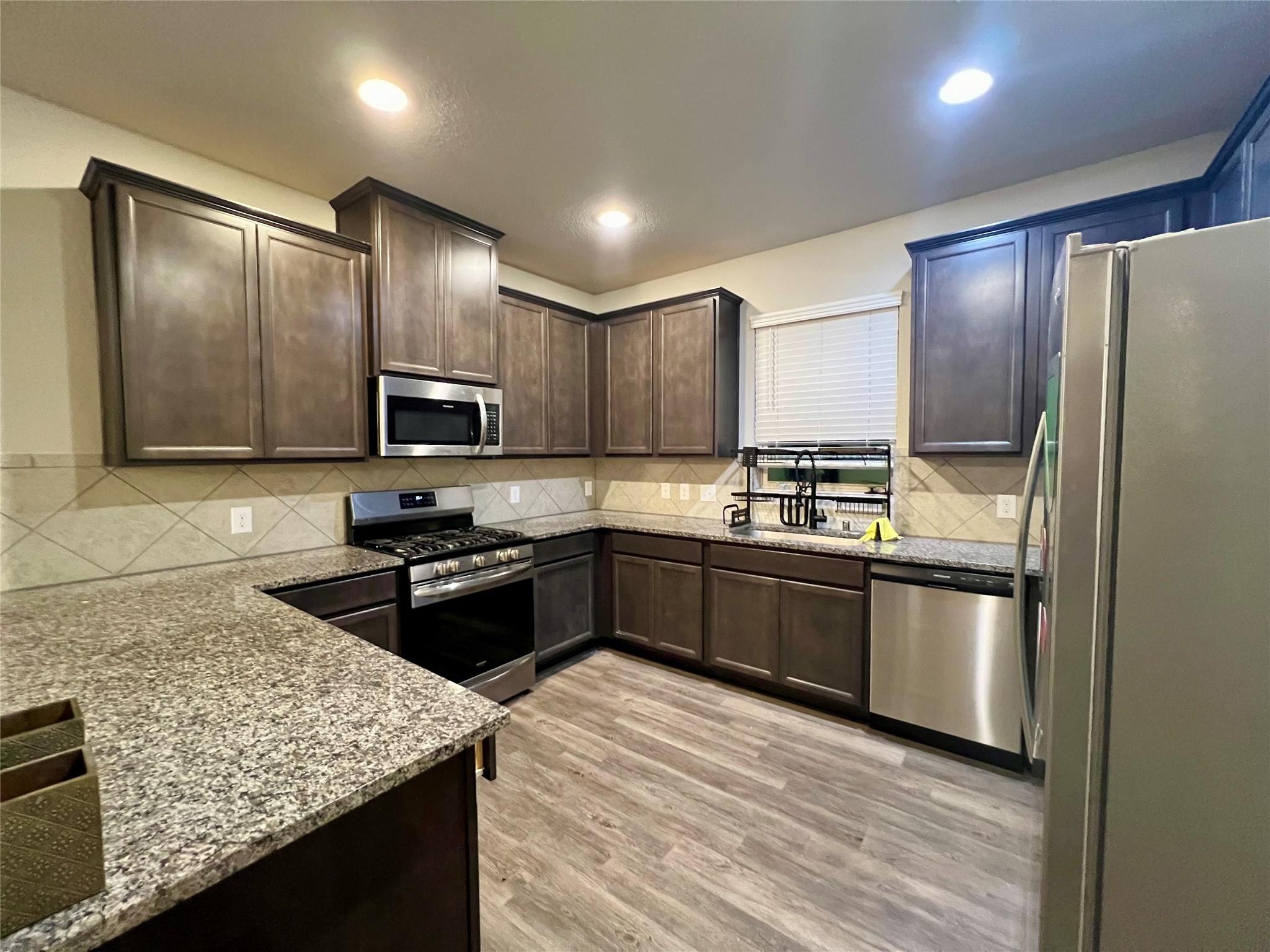 10036 Gold Finch Run Magnolia, TX 77354 - Photo 5 of 17 Modern cabinetry and stainless steel appliances, refrigerator included!
