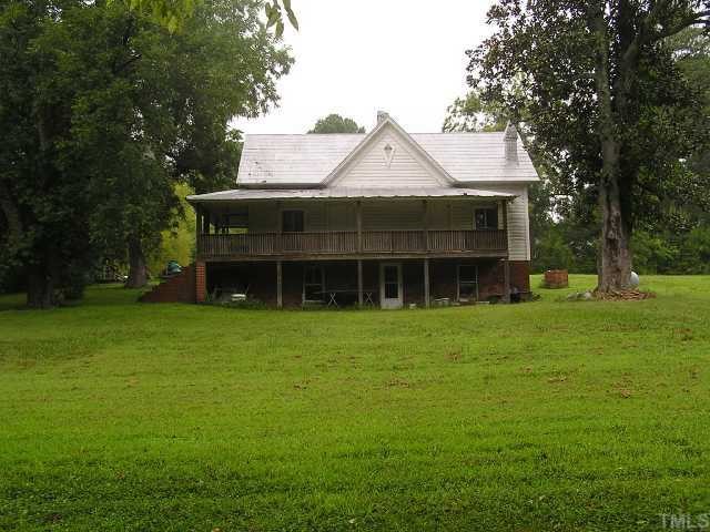 42 George Ray Road Moncure, NC 27559 - Photo 3 of 4 a front view of a house with a garden