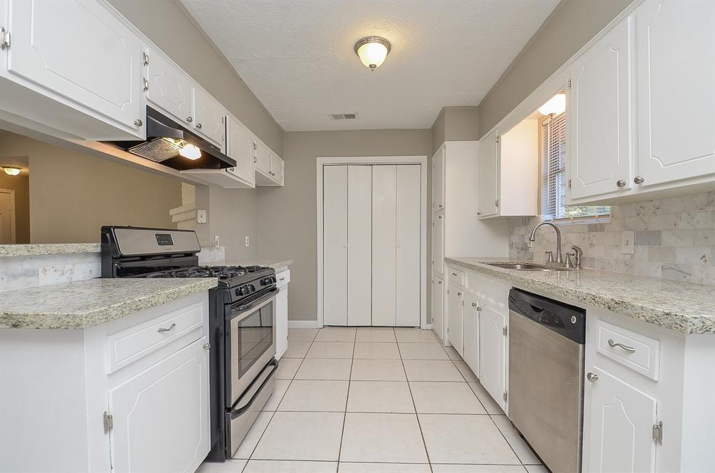 a kitchen with stainless steel appliances granite countertop a stove a sink and a granite counter tops