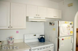 4 Wescott Court Riverside, CT 06878 - Photo 5 of 7 a kitchen with stainless steel appliances a refrigerator and cabinets