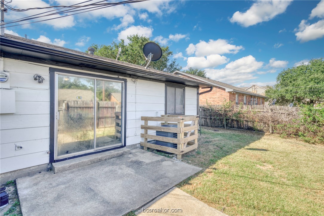 1203 Spring Loop, Unit A College Station, TX 77840 - Photo 12 of 13 Entrance to property with a patio area and a lawn