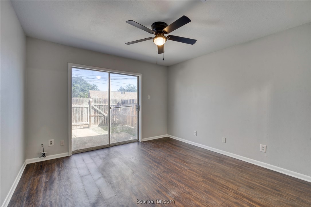 1203 Spring Loop, Unit A College Station, TX 77840 - Photo 7 of 13 Empty room with dark wood-type flooring and ceiling fan
