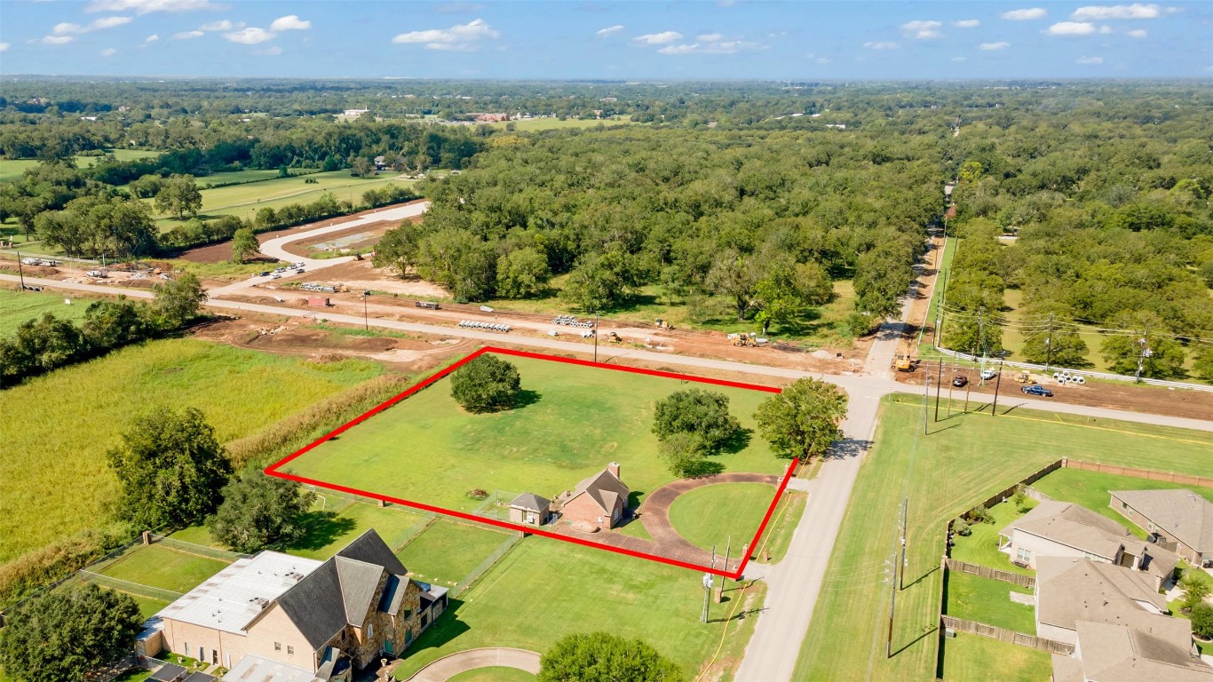 Expansive 1.9-acre lot with a cozy home, offering the perfect quest home to your dream residence.  Also a great location for your commercial venture such as retail center or Convenience Store. 