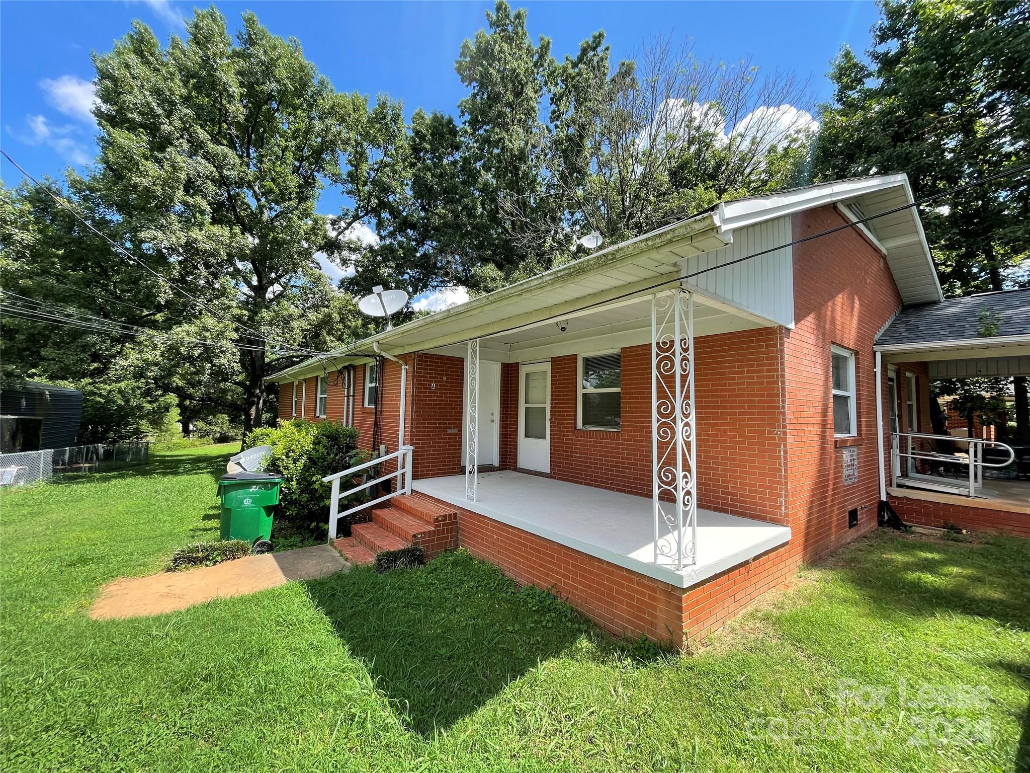 a view of a house with a yard porch and sitting area