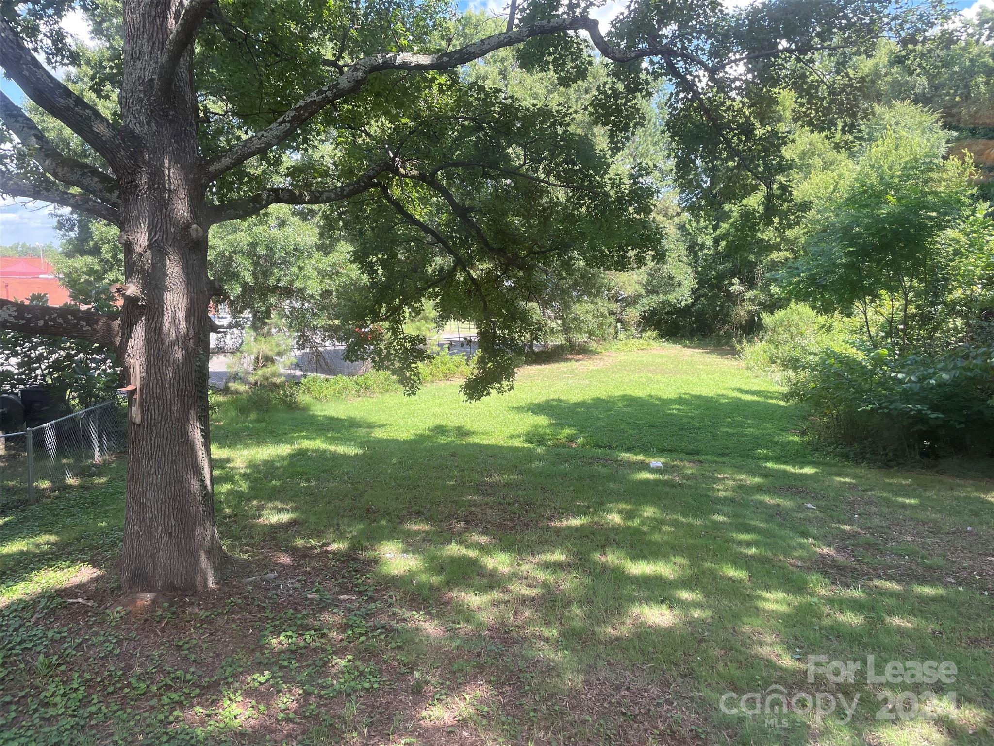 7228 Tuckaseegee Road, Unit A Charlotte, NC 28214 - Photo 7 of 7 a view of a trees with a yard