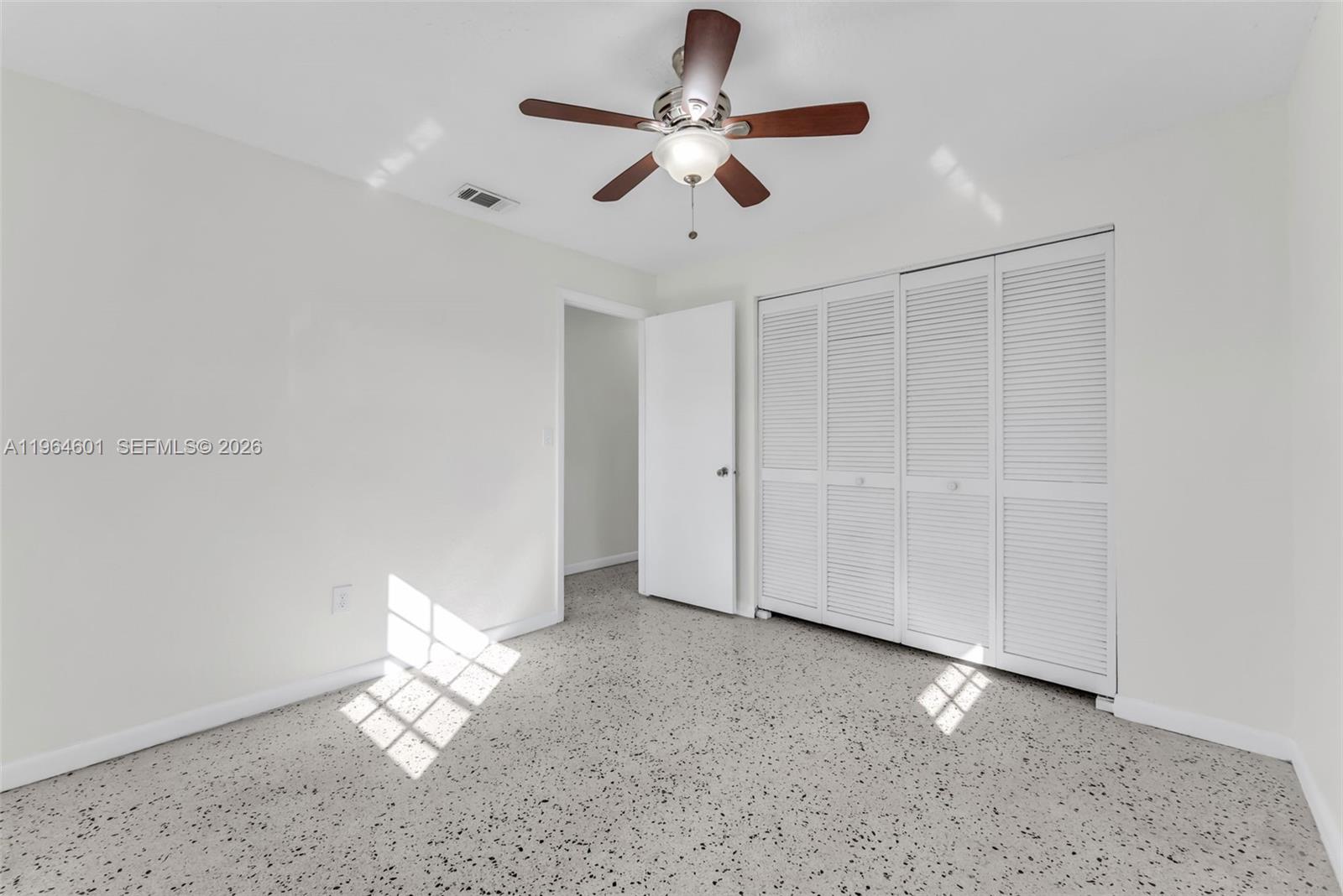 15231 Southwest 302nd Street Homestead, FL 33033 - Photo 22 of 30 a view of an empty room with chandelier fan