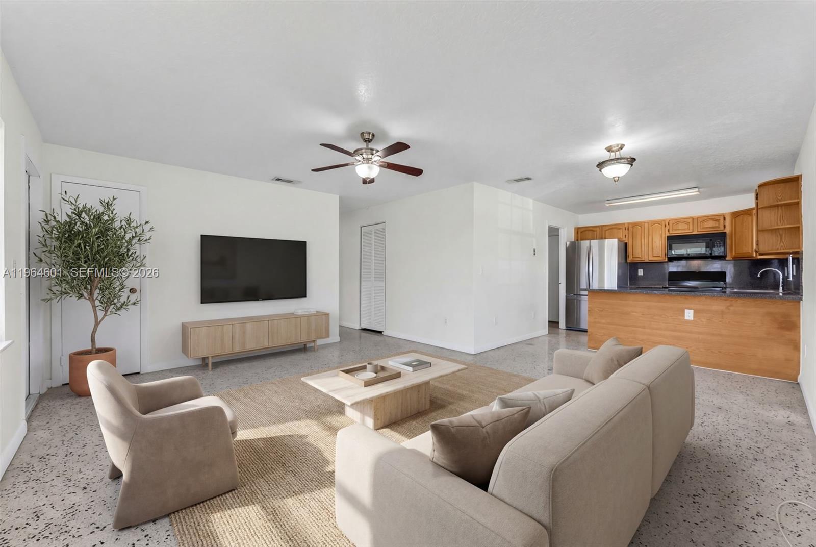 15231 Southwest 302nd Street Homestead, FL 33033 - Photo 4 of 30 a living room with furniture and a flat screen tv