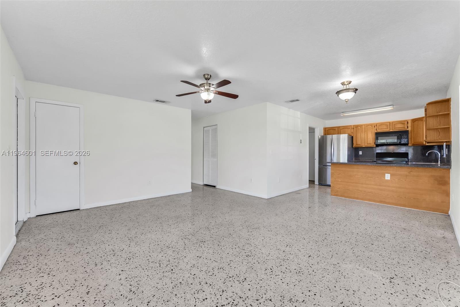 15231 Southwest 302nd Street Homestead, FL 33033 - Photo 5 of 30 an empty room with a kitchen and a sink