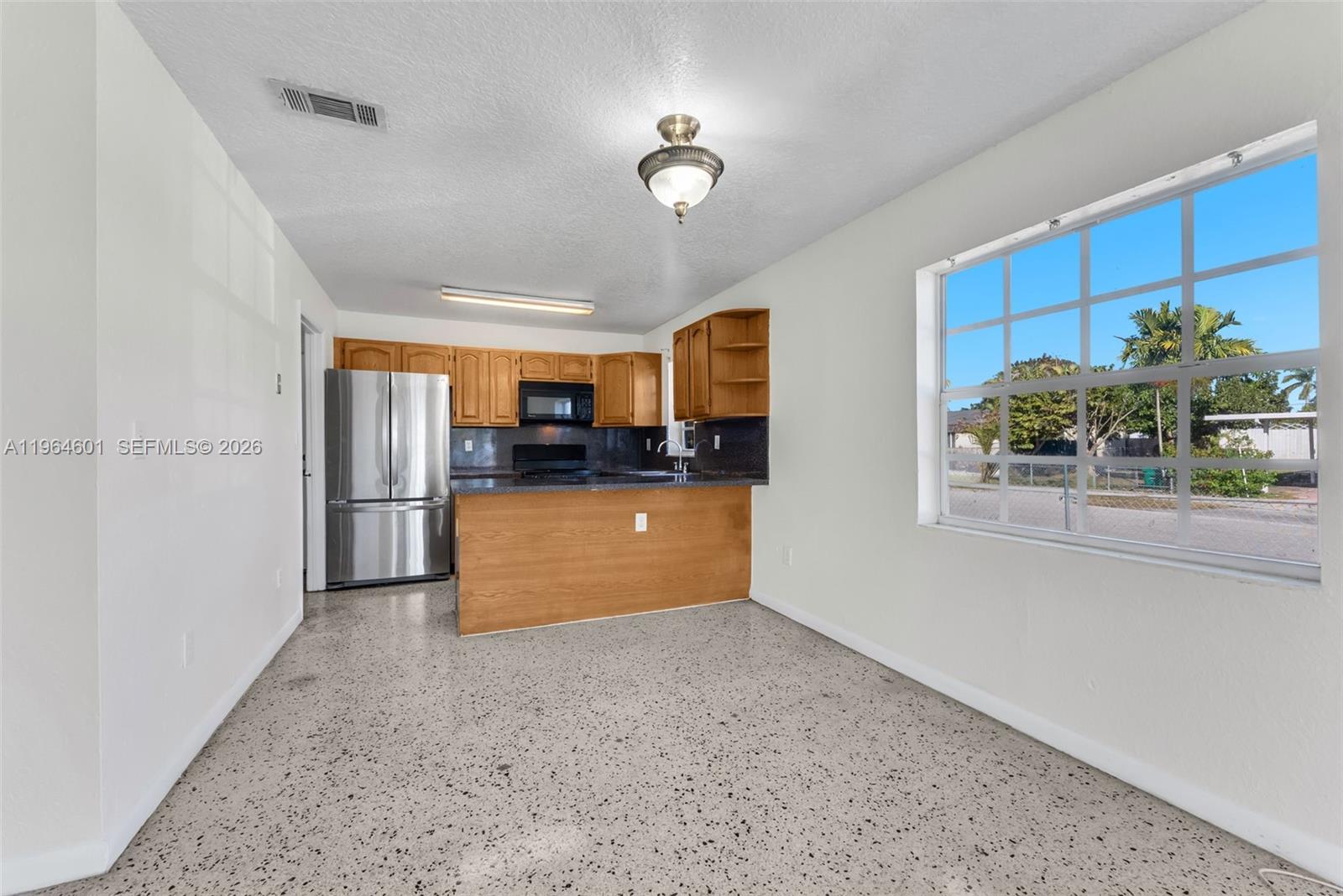 15231 Southwest 302nd Street Homestead, FL 33033 - Photo 9 of 30 a kitchen with stainless steel appliances granite countertop a refrigerator and a sink
