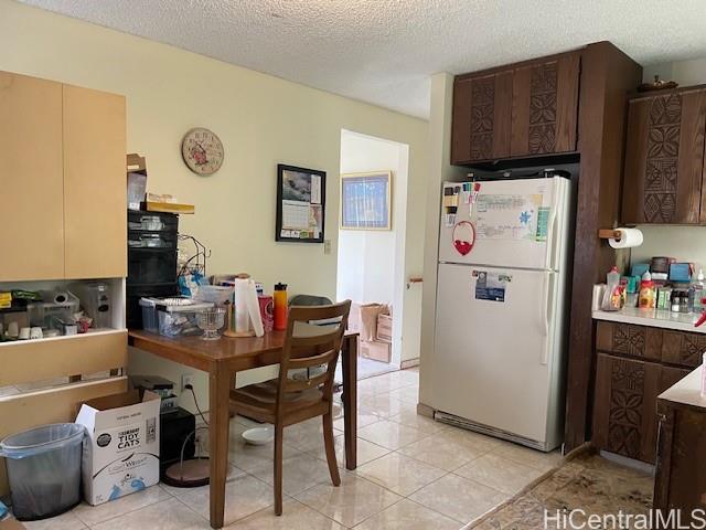 47-166 Wailehua Road Kaneohe, HI 96744 - Photo 14 of 17 a white kitchen with a refrigerator a stove and a dining table